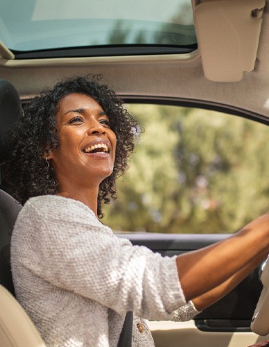 Woman smiling while driving