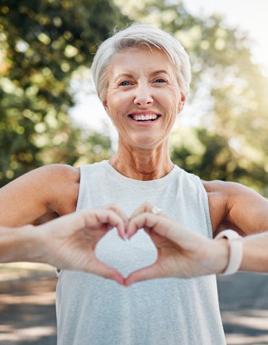 Lady makes shape of heart with her hands