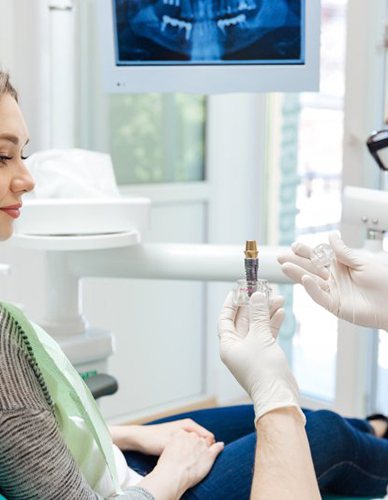 a dentist explaining dental implants to a patient