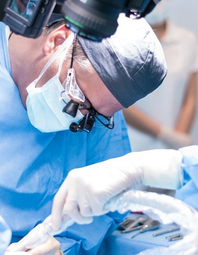 an oral surgeon performing dental implant placement