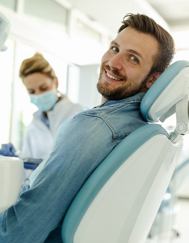 Man smiling while sitting in treatment chair