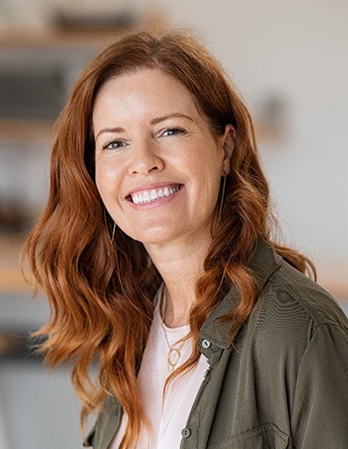 Closeup of woman with auburn hair smiling