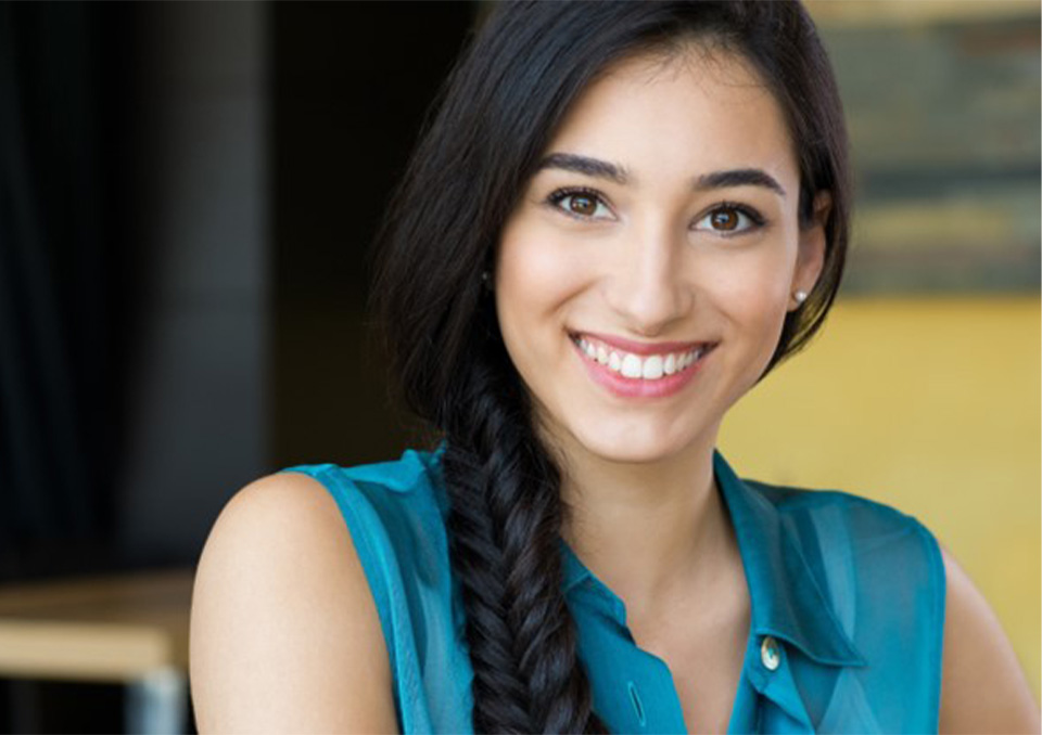 Smiling woman with long dark hair in a braid