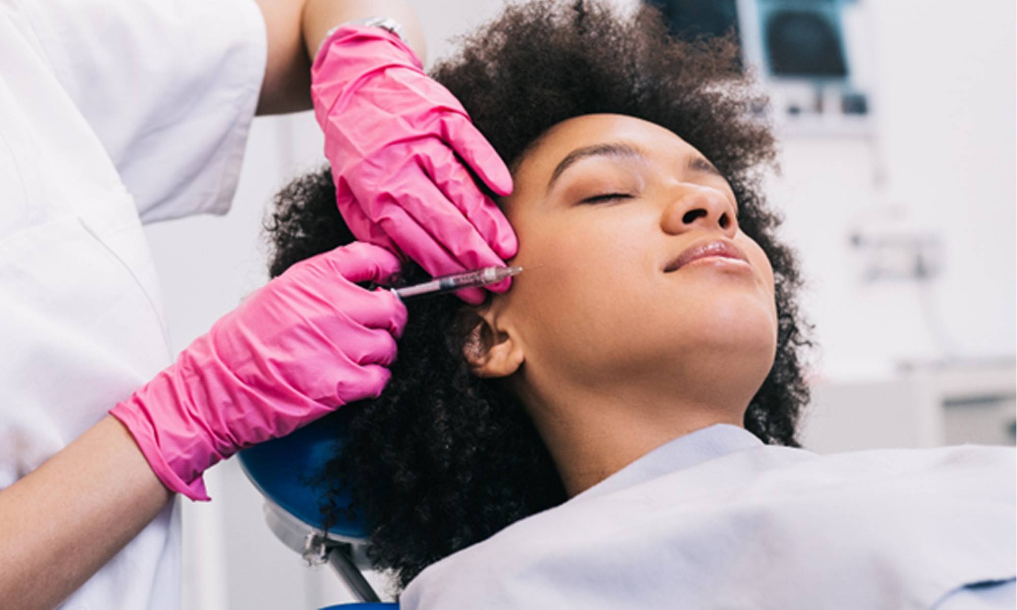 a woman receiving BOTOX injections in her face 