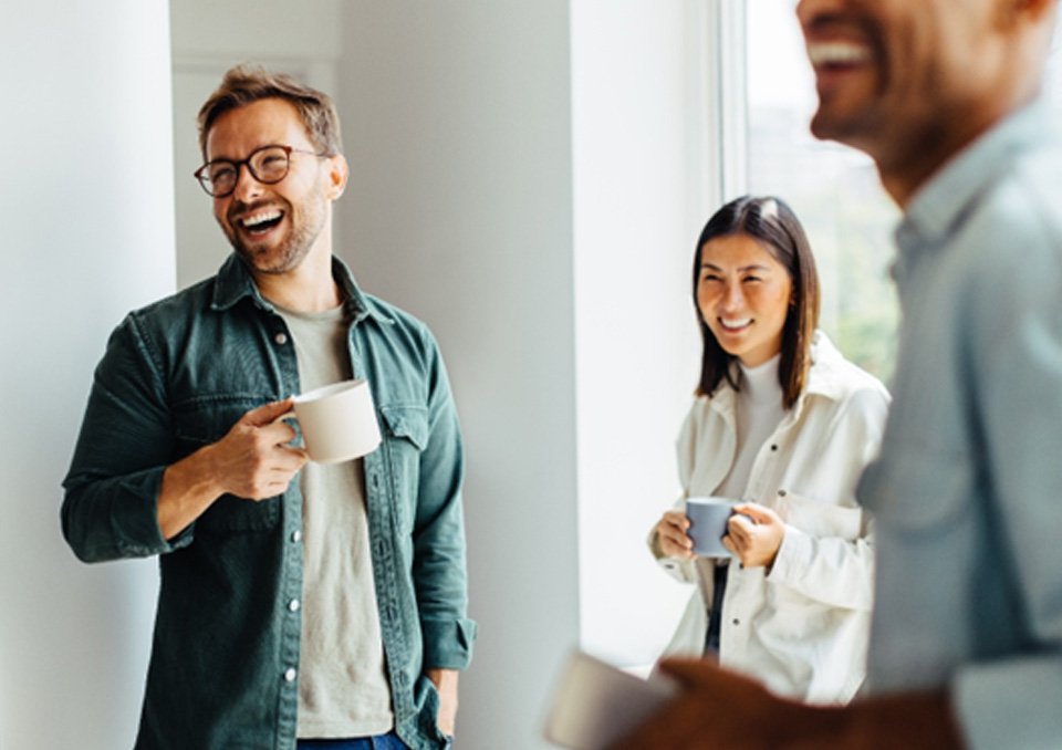 friends drinking coffee and laughing together  