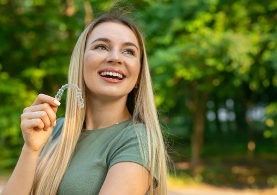 Woman with clear aligner in Richardson