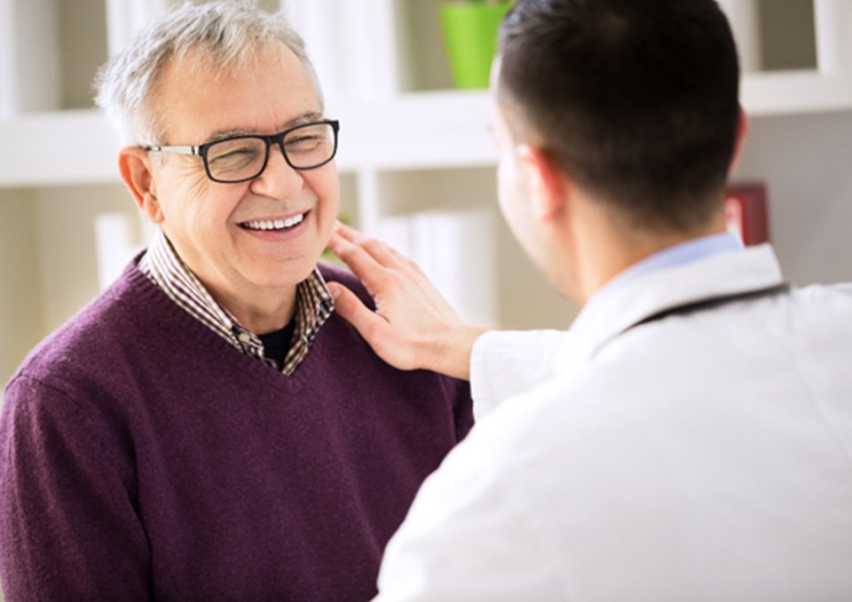 Dentist talking to dental implant candidate in Richardson
