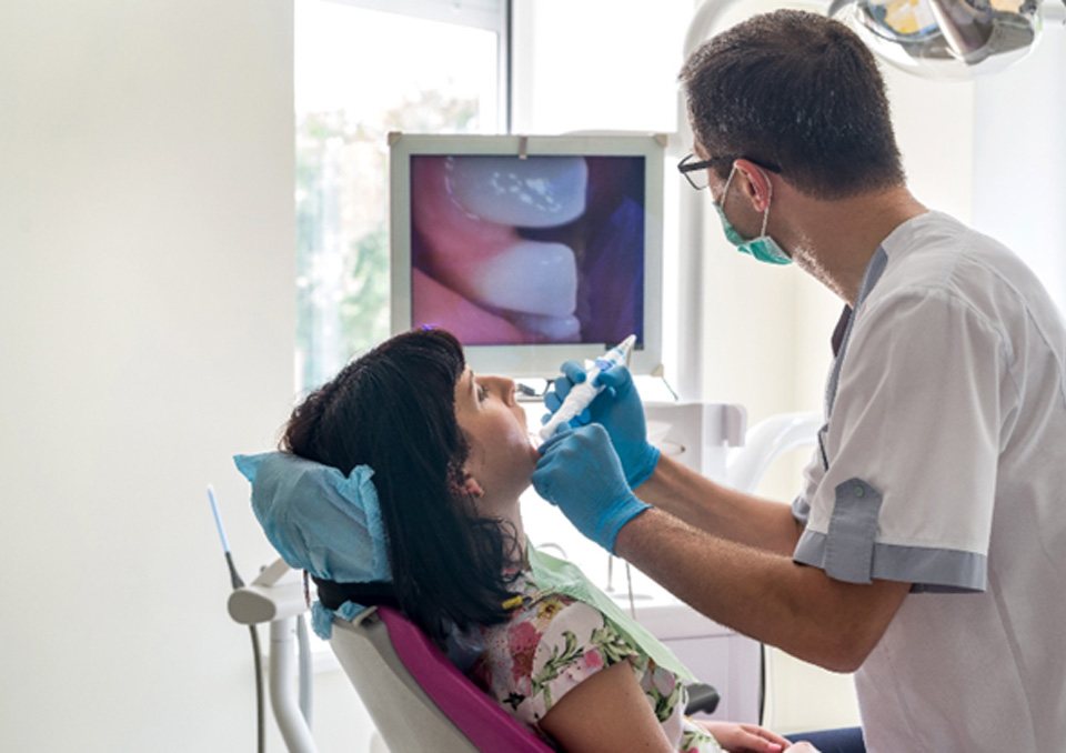 dentist using intraoral camera