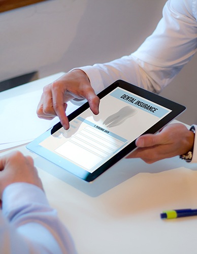 Patient reviewing dental insurance paperwork