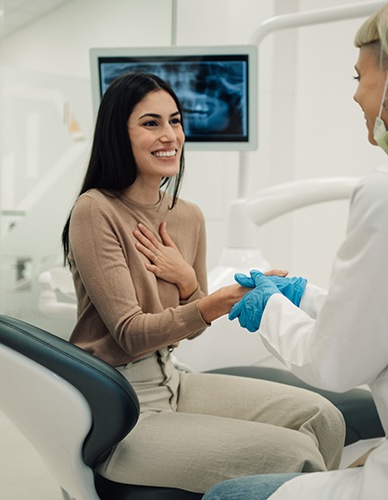 Smiling patient shaking dentist's hand
