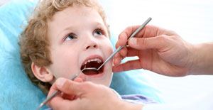 Dentist providing pediatric dentistry treatment