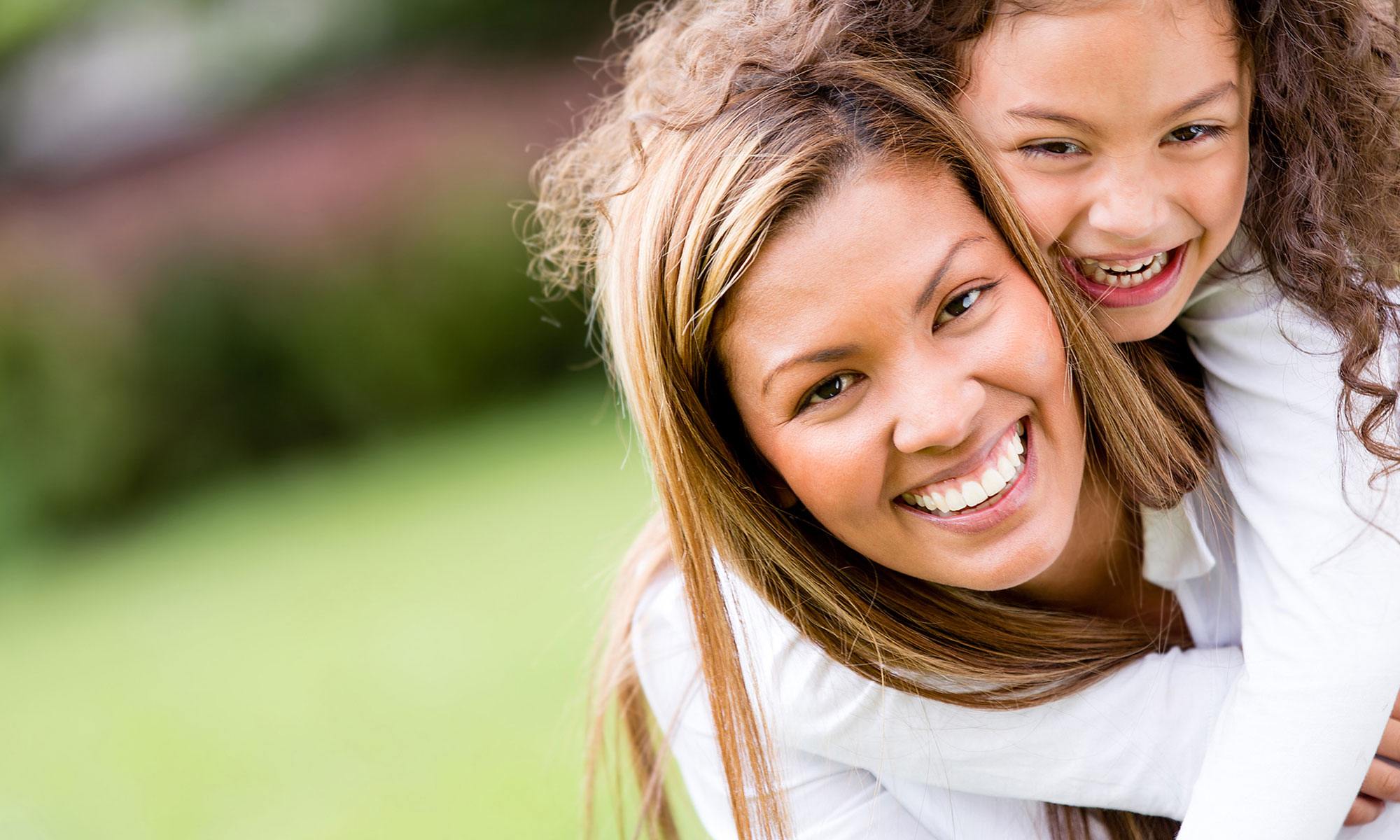 Mother and child smiling together after family dentistry visit