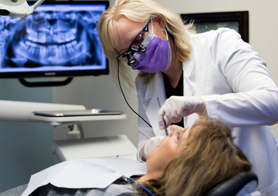 Doctor Sample placing a dental corwn