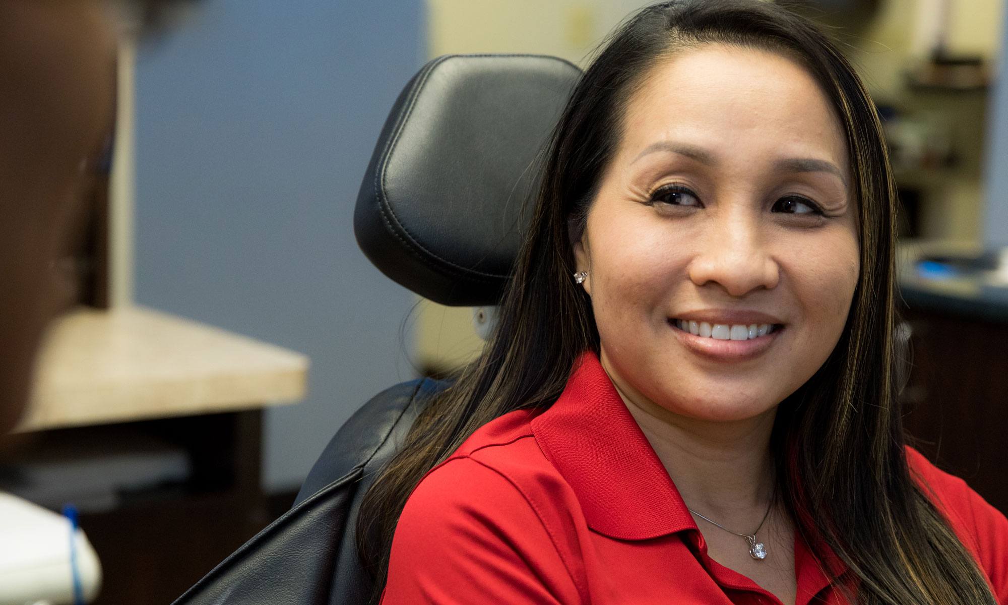 Woman smiling at dentist after full mouth reconstruction