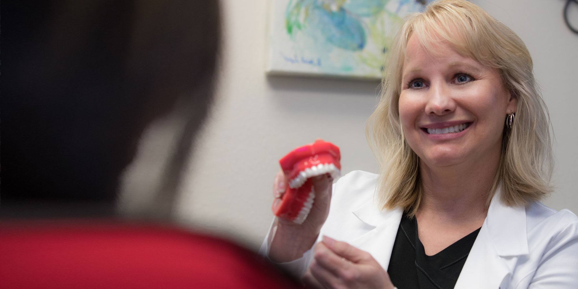 Dentist showing patient a smile model