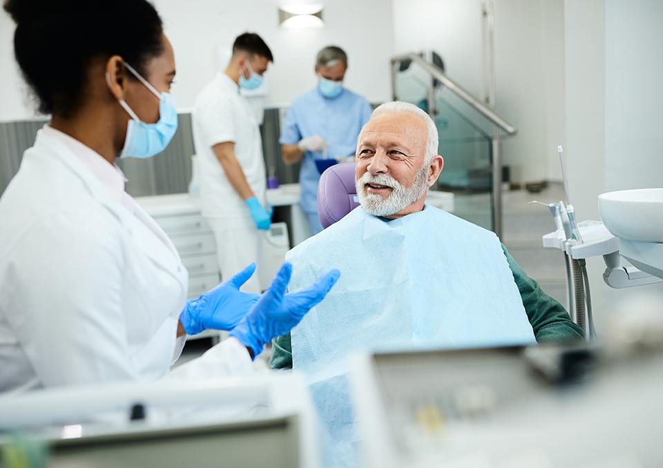 Dentist talking to smiling patient