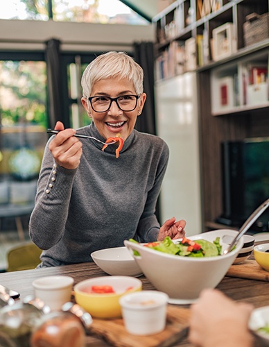 Smiling woman having lunch with friend