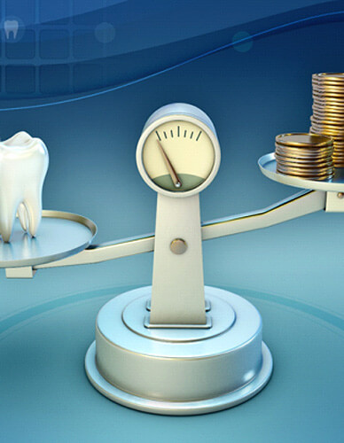 tooth and coins on a balance scale