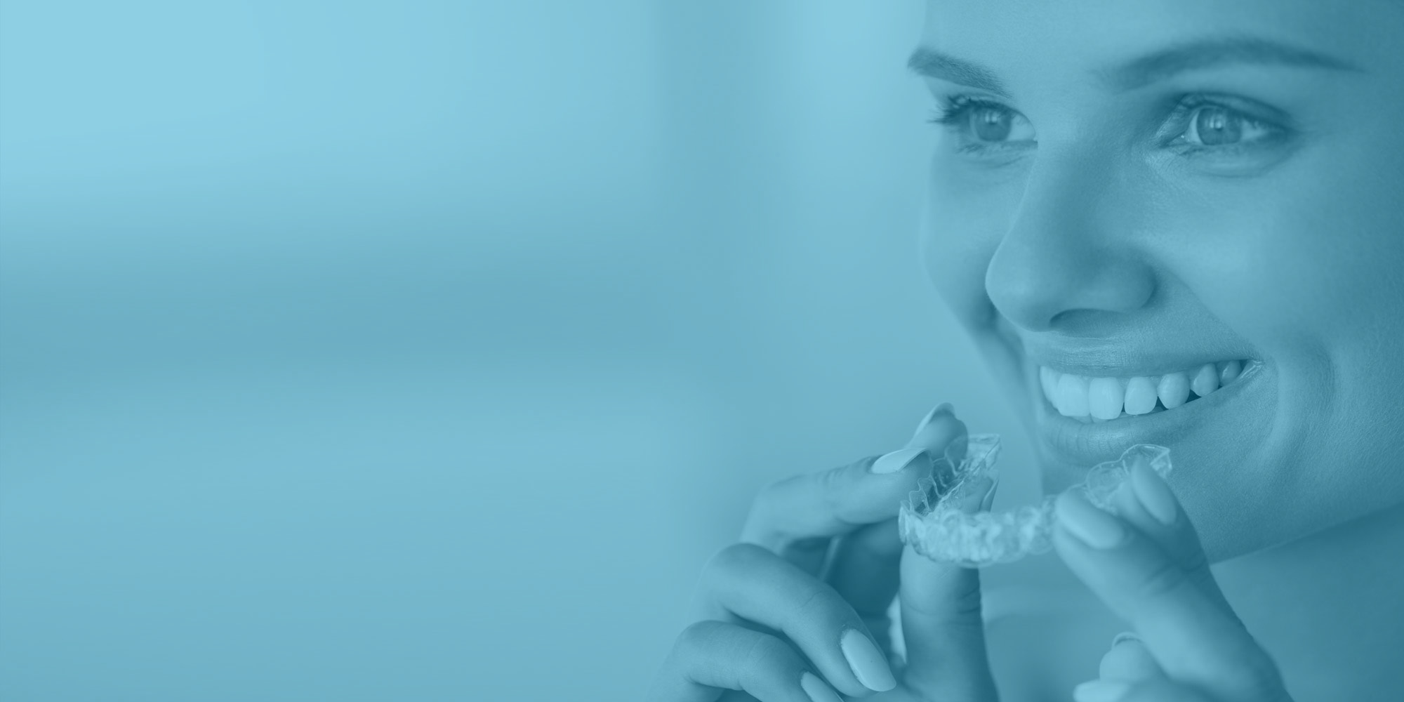 Smiling woman placing an Invisalign tray