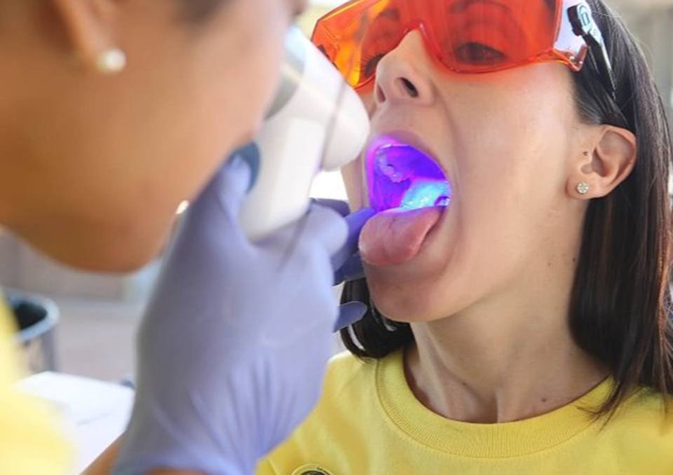 Woman during oral cancer screening in Richardson