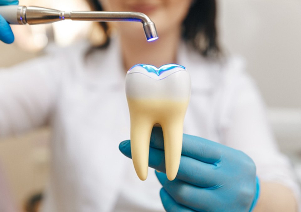 dentist using light on tooth