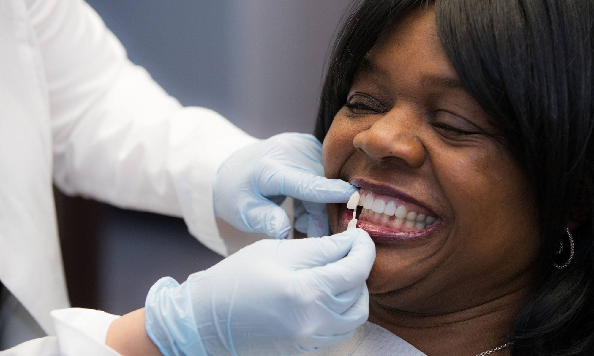 Woman's smile compared to porcelain veneers shade option