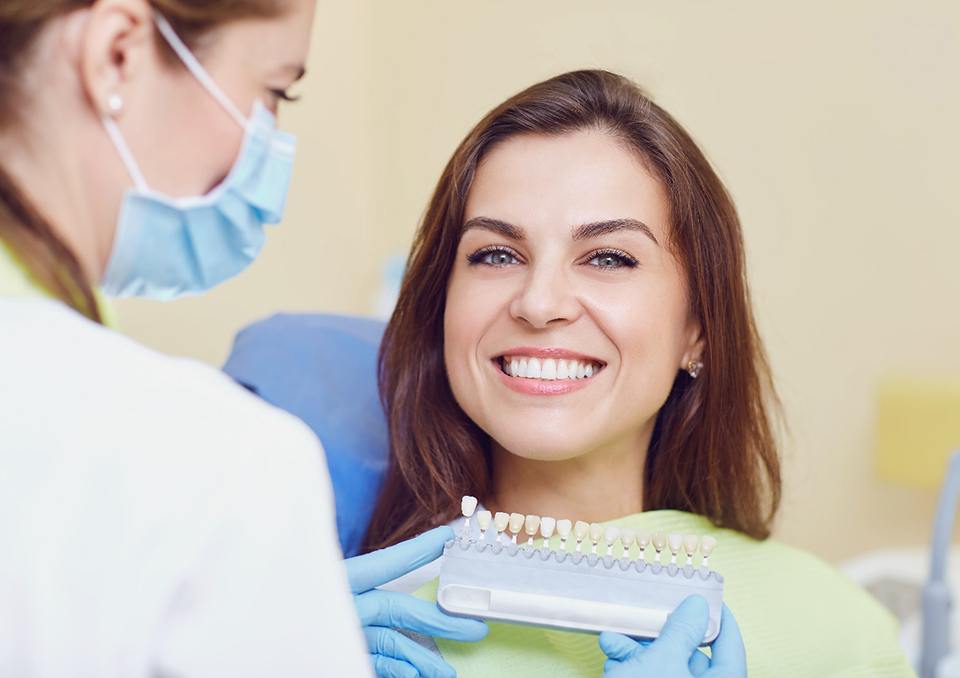 smiling patient with the color guide 