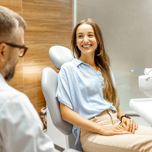 Female patient smiling at dentist at dental appointment