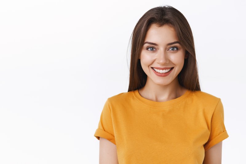 closeup of patient smiling after receiving dental implants  