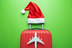 Suitcase with festive hat and airplane on it