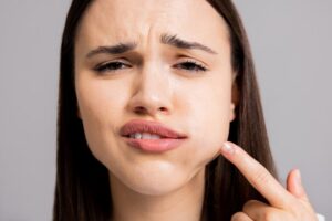 Woman suffering dental emergency. 