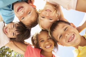 smiling children looking downard