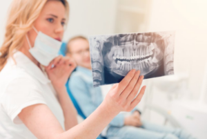 Dentist going over a patient’s X-ray in the treatment room