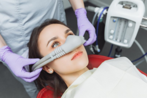 Woman fully awake while dentist administers laughing gas